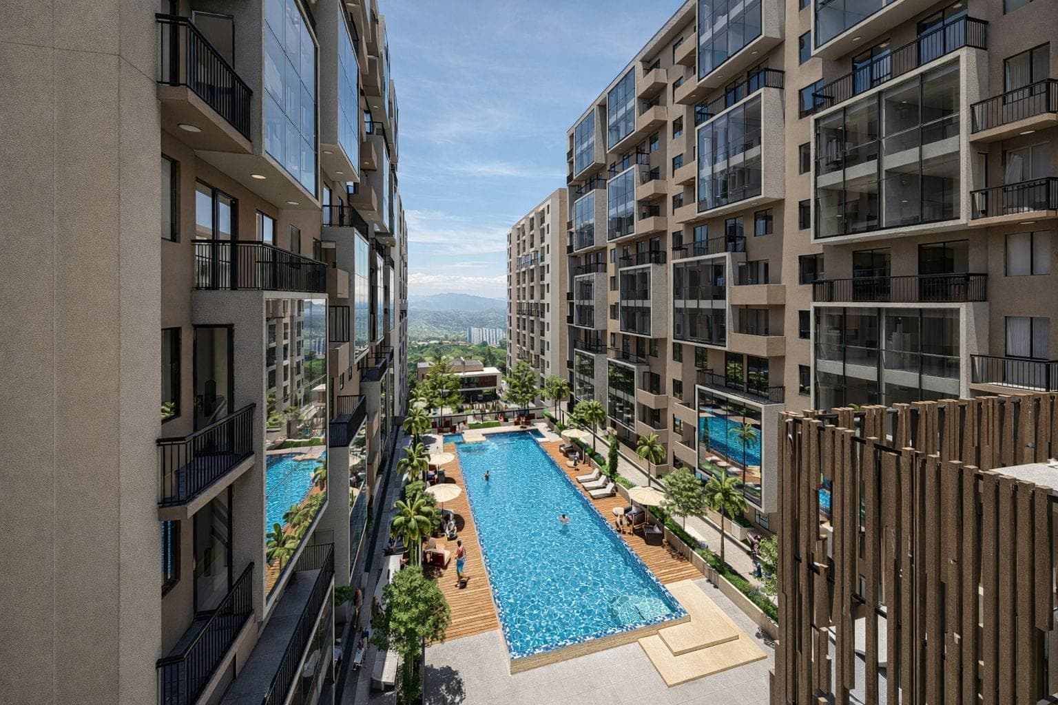 Piscina exterior entre las torres, con terraza en madera y arborización.